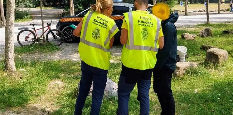 Dos agentes de la Polic&iacute;a Nacional adscrita informan a un visitante en la campa del Parque Nacional de Ordesa y Monte Perdido / DGA