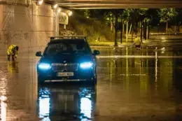 Un veh&iacute;culo parado bajo paso inferior anegado por el agua de las tormentas registradas este domingo en Zaragoza y las localidades de alrededor. / MARCOS CEBRI&Aacute;N
